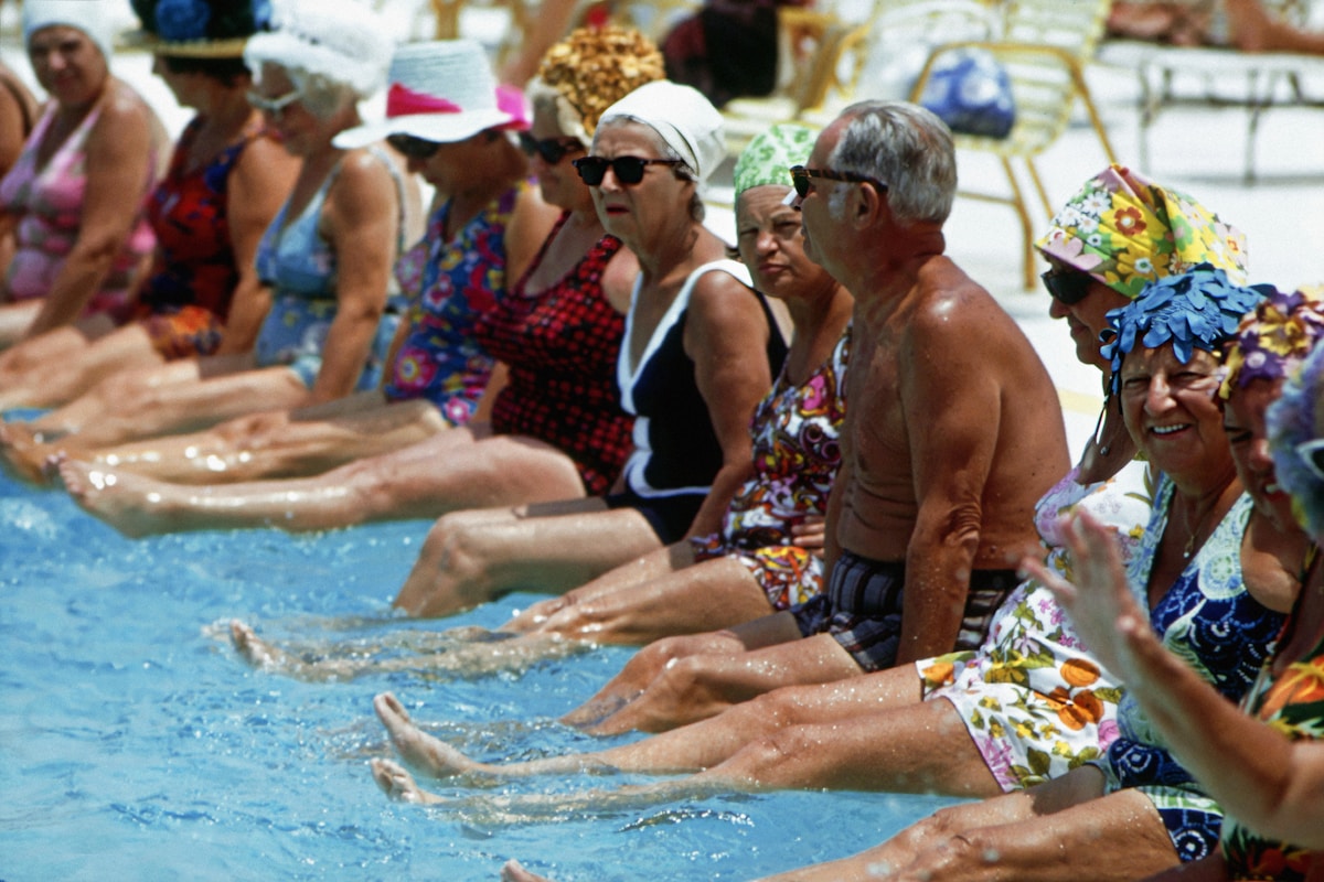 Seniors participating in a chair yoga class at a community center
